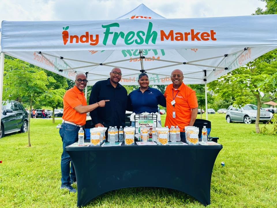Indy Fresh Market team at a community event tent